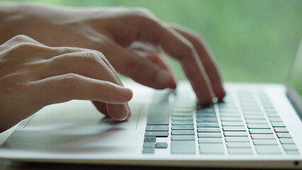 Closed up Businessman Hand Typing work on Laptop computer in office. 