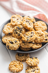Wholegrain oat cookies. Cookies with oatmeal and raisins on white table.