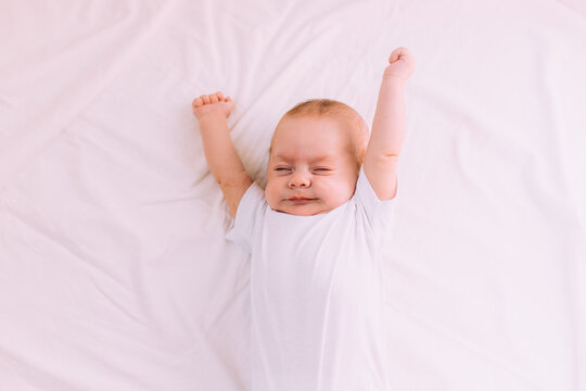 The baby stretches after sleeping Lifestyle . A happy child. Children's article.