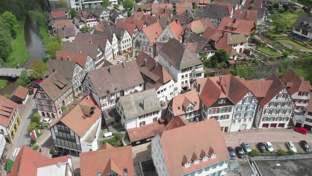 Aerial ascending shot over a historic german village with traditional and half-timbered houses