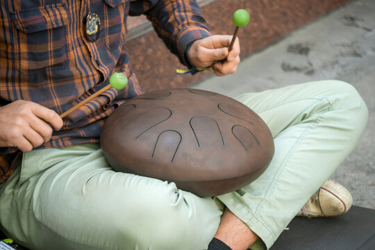 man playing hang drum