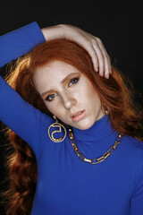 red-haired girl in blue clothes with bright make-up