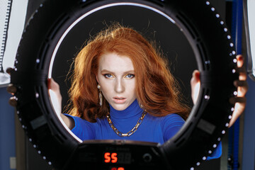 red-haired girl in blue clothes with bright make-up