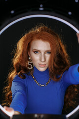 red-haired girl in blue clothes with bright make-up
