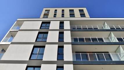 Modern luxury residential flat. Modern apartment building on a sunny day. Apartment building with a blue sky. Facade of a modern apartment building.