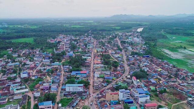 A wide top view of small town amidst agricultural lands