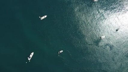 Aerial yacht on calm sea. Luxury cruise trip. View from above of white boats on deep blue water. Aerial view of rich yacht sailing sea. Summer journey on luxury ship.