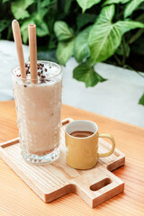 Iced coffee and black coffee in a mug, morning in a cafe.