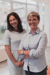 Portrait of a two teacher in a preschool institution, in the background of the classrooms