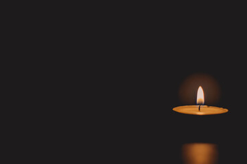candle light burn against black background