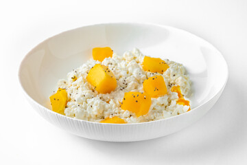 Breakfast of cottage cheese with peach and mango.Balanced, nutritious, tasty and nutritious food. Ready-made menu for a restaurant or for delivery. Isolated on a white background