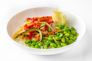 White rice with beans and cooked vegetables. Balanced, nutritious, tasty and nutritious food. Ready-made menu for a restaurant or for delivery. Dish in a white plate isolated on a white background.