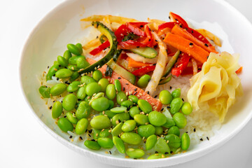 White rice with beans and cooked vegetables. Balanced, nutritious, tasty and nutritious food. Ready-made menu for a restaurant or for delivery. Dish in a white plate isolated on a white background.