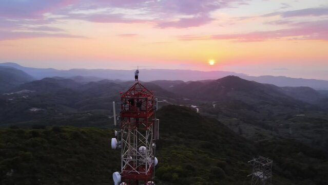 Tower climbing with an incredible view. A dose of adrenaline. Orbit drone video during sunset.