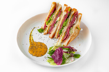 Ham sandwich. Balanced, nutritious, tasty and nutritious food. Ready-made menu for a restaurant or for delivery. Dish in a white plate isolated on a white background.