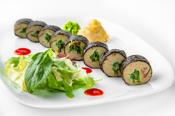Rolls with fish paste and chuka. Balanced, nutritious, tasty and nutritious food. Ready-made menu for a restaurant or for delivery. Dish in a white plate isolated on a white background.