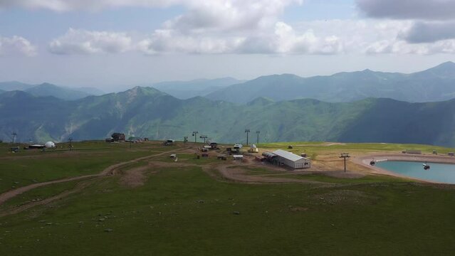 summer day gudauri ski resort mountain top lift station aerial panorama 4k georgia