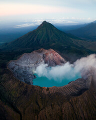 Stunning sunrise views from the top of Ijen volcano with a blue sulfur lake and blue fire in Java Indonesia © marina