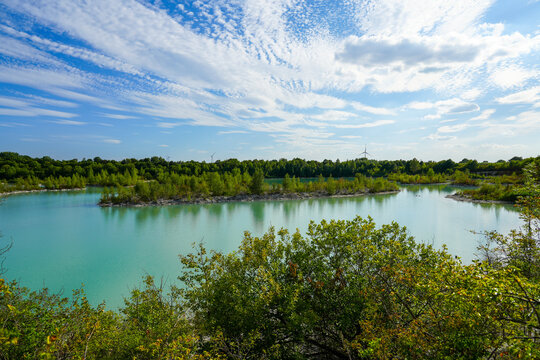 View of the Dyckerhoff lake in Beckum. Quarry west. Blue Lagoon. Landscape with a turquoise blue lake and the surrounding nature.
