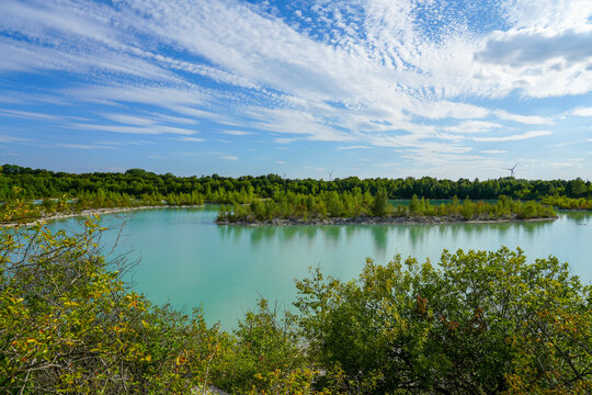 View of the Dyckerhoff lake in Beckum. Quarry west. Blue Lagoon. Landscape with a turquoise blue lake and the surrounding nature.
