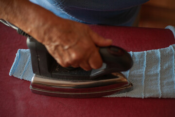 grandmother ironing at home