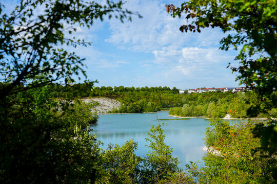 View of the Dyckerhoff lake in Beckum. Quarry west. Blue Lagoon. Landscape with a turquoise blue lake and the surrounding nature.
