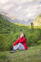 Naklejka na ściany i meble happy romantic girl sitting in the mountains enjoying fresh mountain air and birds singing