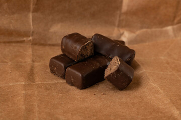 Chocolate candies on kraft paper. Dark chocolate.