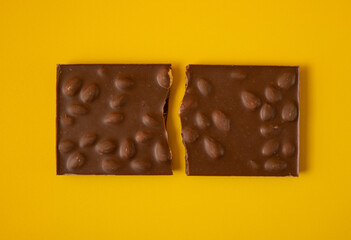 Chocolate bar with nuts. Chocolate break in the middle.