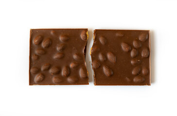 Chocolate with nuts. The chocolate is broken in half.
