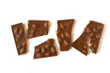 Pieces of chocolate. Broken chocolate bar on white.