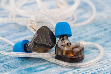 In ear monitor on a tablature background. Custom in-ear monitors with black plates. Custom in ear...