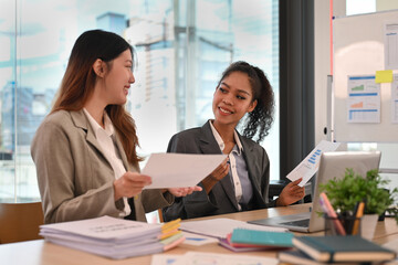 Smiling African businesswoman sharing ideas business strategy with her colleagues at corporate meeting