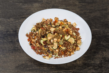 Mixture of spices and dried vegetables on the white dish