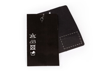 Black hanging tags, one of them with clothing care symbols