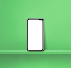 Mobile phone on green wall shelf. Square background