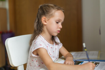 Girl doing her homework from at her desk