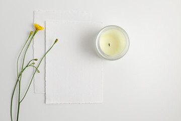 Watercolor paper mockup with daisy and candle