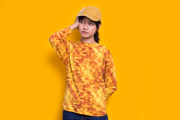 young asian beautiful woman mad angry emotional shouting on yellow background
