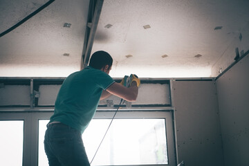 man works with a drill.