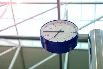 large modern clock in airport on a beautiful background, geometric shapes on the ceiling, concept delay, flight cancellation, arrival time, don't miss your flight, Frankfurt, Germany