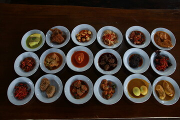 Minangkabau traditional food is being served on the dining table