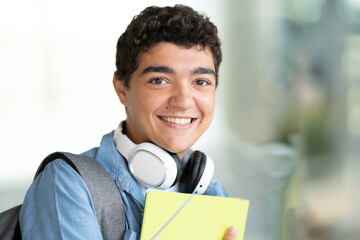 Closeup portrait of hispanic teenager student smiling and looking at camera.