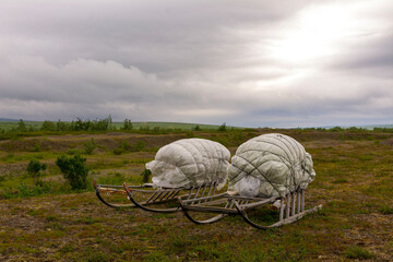 Wooden sledges with cargo in the tundra in the north in summer.