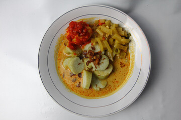 Lontong sayur or vegetable rice cake is an Indonesian traditional rice dish made of pieces of lontong served in coconut milk soup with shredded chayote, tempeh, tofu, hard-boiled egg, and sambal.