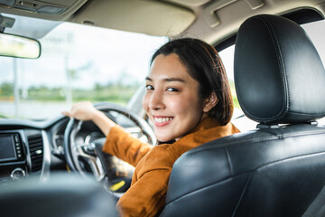 Young beautiful asian women getting new car. she very happy and excited. Smiling female driving...
