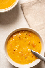 Homemade yellow split pea lentil soup served in a bowl. Arhar dal. View from above.