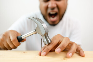 The carpenter was injured by hammer and nails. He misused the hammer and stuck it in his hand. Accidents during work require accident insurance.