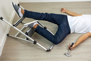 Carpenter falling down from ladder head hit the ground and fainted. Accident at home careless