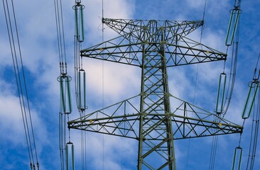 the top of the High Voltage Electric Pylon And Electrical Wire. Electricity Poles. Power And Energy